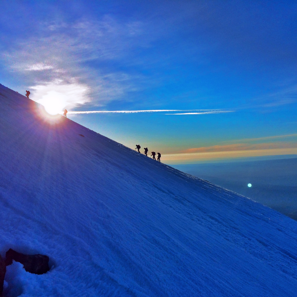 Sunrise Silhouetting Climbers on Mt. Adams